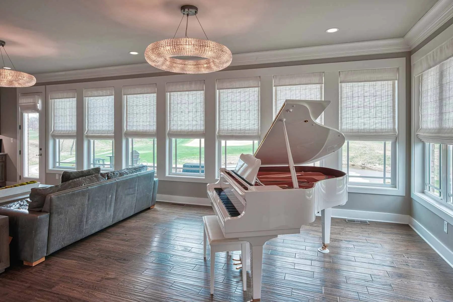 A bright living room with coordinated fabric Roman shades
